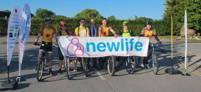 WORKERS CELEBRATE COMPANY MILESTONE CYCLING TO RAISE MONEY FOR CHILDREN