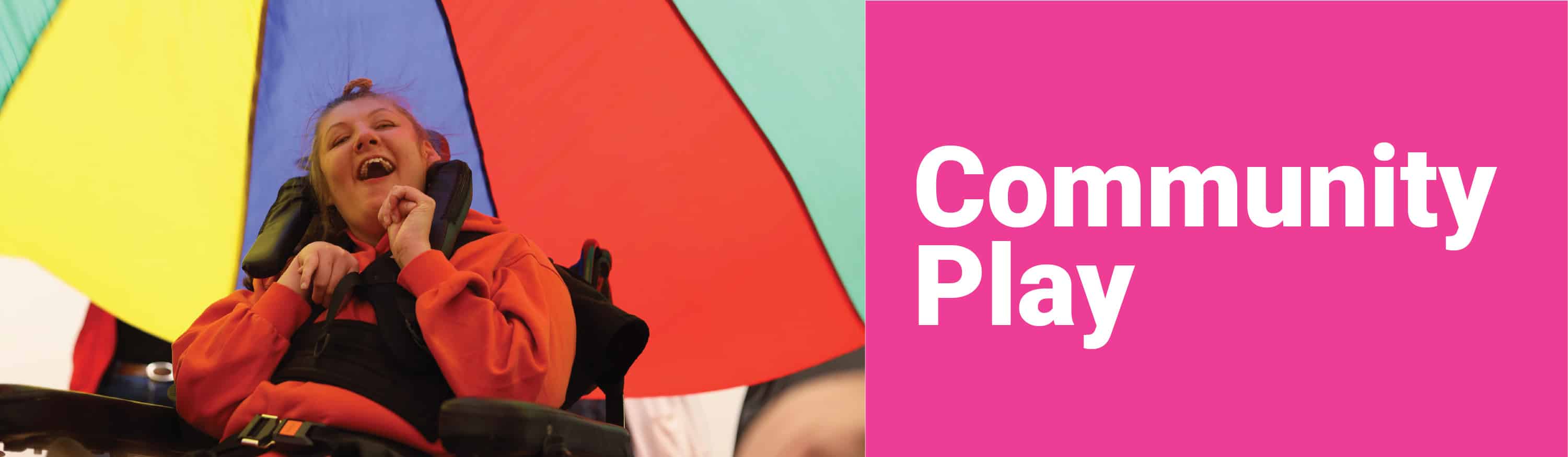 community play header with image of girl playing underneath a play parachute